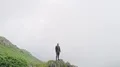 The flight near the man standing on a mountain cliff 4k or 4k+ Resolution