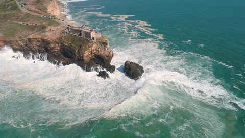 Flight near Rock and Lighthouse near City of Nazare Stockbeeldmateriaal 89905383
