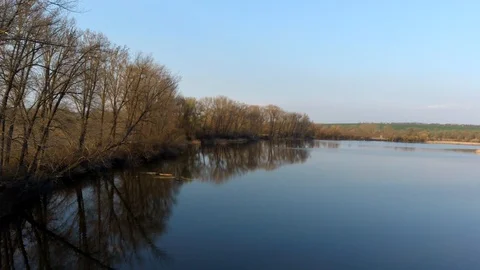 Flight next to left bank of large fish pond during spring season 스톡 동영상 127285168
