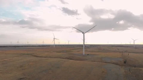 Flight next to the wind turbines against the backdrop of dawn 4K Stock Footage 207809738