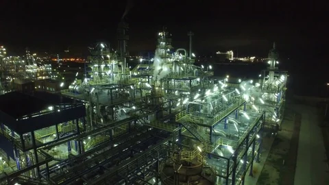 Flight at night over a lighted chemical installation,  aerial view Stock Footage 73661428