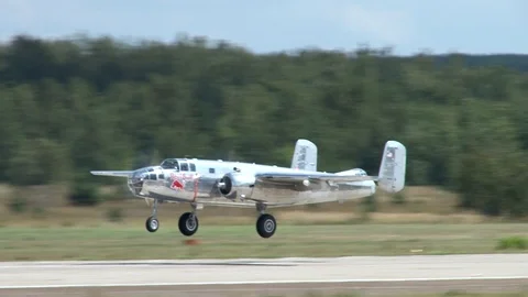 Flight of North American B-25 Mitchell bomber over runway followed by landing. Video stock 116233050