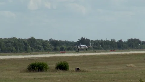 Flight of North American Mitchell B-25 bomber at low altitude above runway. Stock Footage 120778683