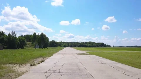 Flight over the acceleration strip of the aircraft, front view, around hangars Video stock 138035072