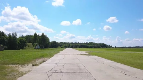Flight over the acceleration strip of the aircraft, front view, around hangars Video stock 138035093