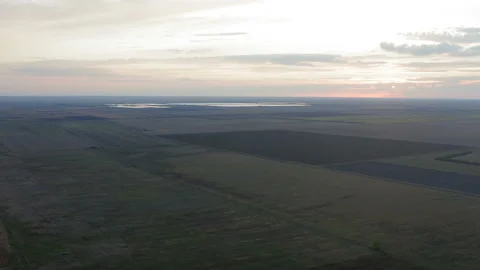 Flight over agricultural fields at sunset  with dramatic sky Stockbeeldmateriaal 138649443