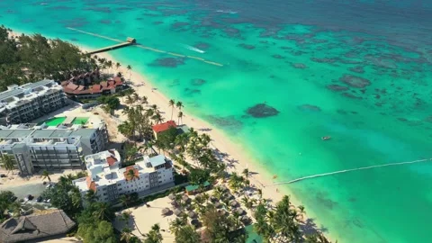 Flight over the all-inclusive beach resort territory in tropical Punta Cana Stock Footage 306678443