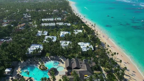 Flight over the all-inclusive beach resort territory in tropical Punta Cana Stock Footage 308027071