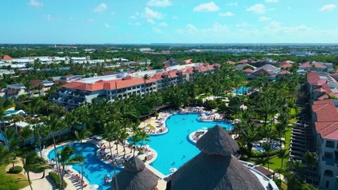 Flight over the all-inclusive beach resort territory in tropical Punta Cana Stock Footage 308027724