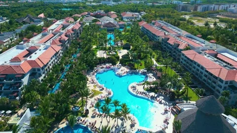 Flight over the all-inclusive beach resort territory in tropical Punta Cana Stock Footage 308027827
