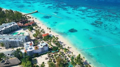 Flight over the all-inclusive beach resort territory in tropical Punta Cana Stock Footage 309235895