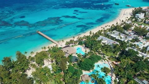 Flight over the all-inclusive beach resort territory in tropical Punta Cana Stock Footage 309945301