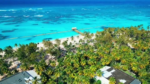 Flight over the all-inclusive beach resort territory in tropical Punta Cana Stock Footage 309945523