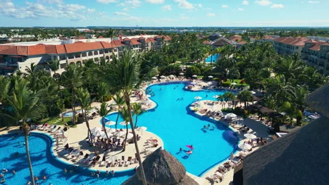Flight over the all-inclusive beach resort territory in tropical Punta Cana Stock Footage 311340392