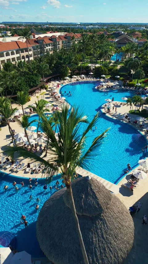 Flight over the all-inclusive beach resort territory in tropical Punta Cana Stock Footage 311340742
