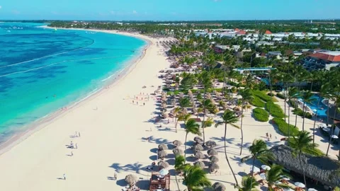 Flight over an all-inclusive hotel beach on a bright sunny day in Punta Cana 스톡 동영상 307209352