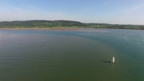 Flight over an Anglesey beach on a summer’s day Stock Footage 234070015