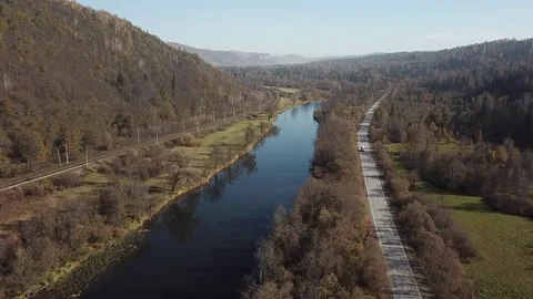 Flight over the autumn river, road and the railway Stock Footage 81003954