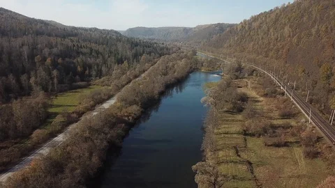 Flight over the autumn river, road and the railway Stock Footage 81003973