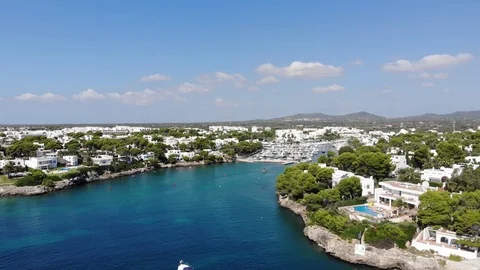 Flight over the bay of Cala D'or, village Cala D'or, Felanix and Porto Petro Stock Footage 95587101
