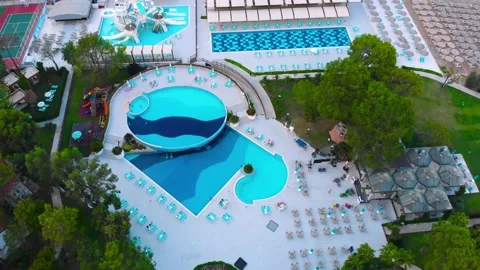 Flight over the beach with umbrellas towards the pool in a luxury hotel Stock Footage 195195523