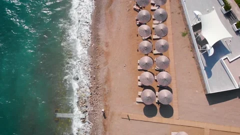 Flight over the beach with umbrellas towards the pool in a luxury hotel Stock Footage 195195699