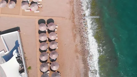 Flight over the beach with umbrellas towards the pool in a luxury hotel Stock Footage 195195820