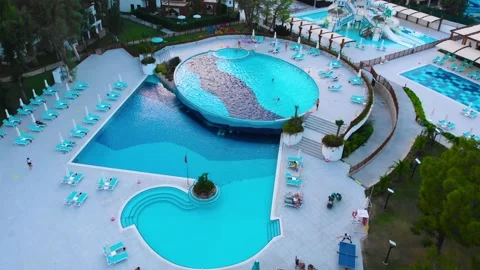Flight over the beach with umbrellas towards the pool in a luxury hotel Stock-Footage 195195895