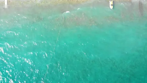 Flight over the beach with umbrellas towards the pool in a luxury hotel Stock Footage 195196748