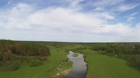 Flight over  beautiful field with trees and river with turn. Aerial   Stockbeeldmateriaal 49972998