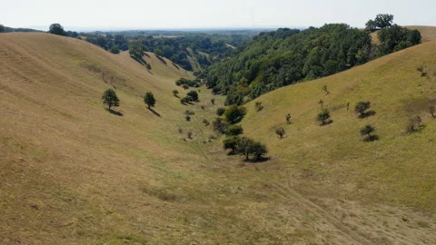 Flight over a beautiful hill type terrain on a sunny day Видео 138710228