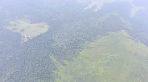 Flight over the beautiful mountain forest in a summer haze Stock Footage 67248646