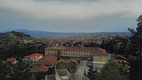 Flight over a big Heart, a road and a village. Stock Footage 273589339