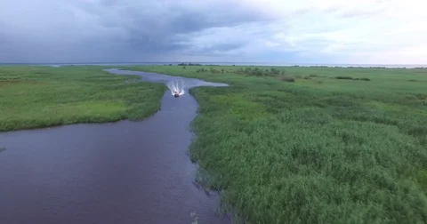 Flight over the boat floating on the river 動画素材 79773085