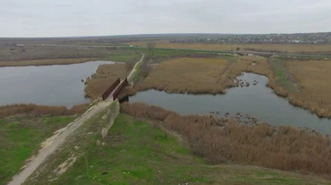 Flight over the bridge across the river and the swamp Stock Footage 63082517