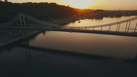 Flight over the bridge and boat near the river city at sunset aerial Stock Footage 76324315