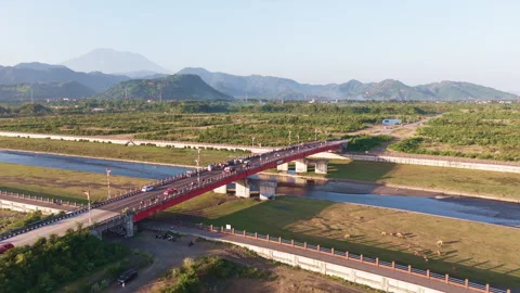 Flight Over Bridge and River Toward Distant Mountains Stock Footage 344870957