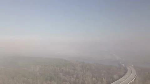 Flight over the bridge in the early sunny morning during fires covered in smoke Stock Footage 207476071