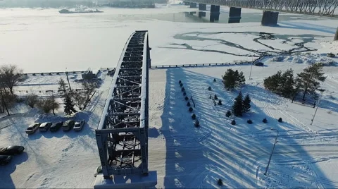 Flight over the bridge element. flying over the frozen river. Bridge over river Stock Footage 60755283