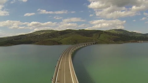 Flight over the bridge lake with background mountains Stock Footage 72165732