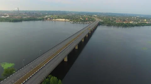 Flight over the bridge over a large river in the area of industrial suburbs Stock-Footage 66525817