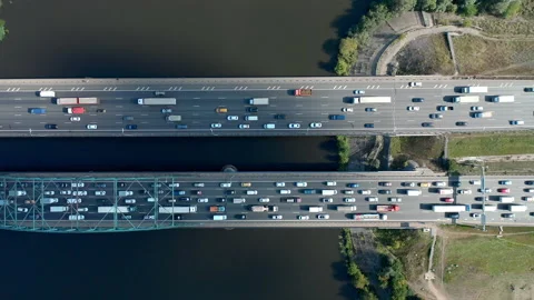 Flight over bridge with traffic over river. Chasing cars by drone. Cars moving. Stock Footage 140272242