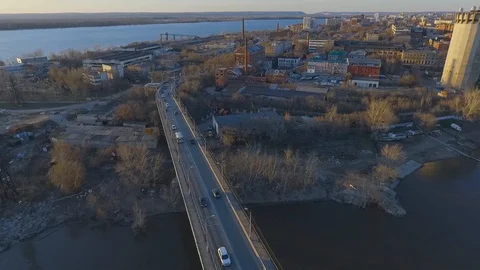 Flight over the busy traffic of cars on a bridge over water. bridge on the river Stock Footage