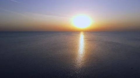 Flight over the calm sea to the setting sun Stock Footage 154634247