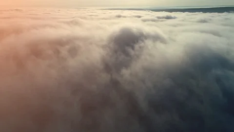 Flight over clouds and fog towards the sun, while little is flying over clouds. Video stock 127166956