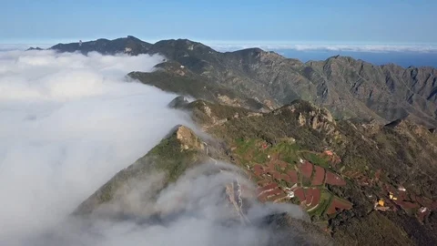 Flight over clouds and mountain road in Anaga, Tenerife Stock Footage 106881619