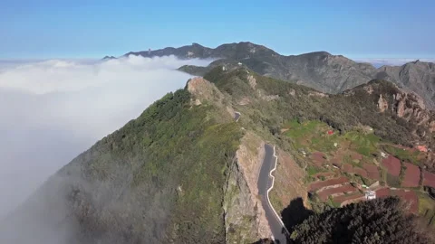 Flight over clouds and mountain road in Anaga, Tenerife Stock Footage 143782577
