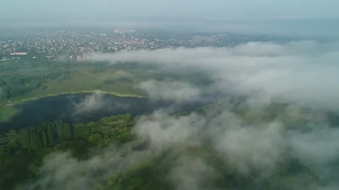 Flight over the clouds that fly away and open the landscape of the city. Stock Footage 138763126