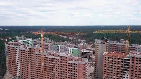 Flight over the construction of a high-rise building made of bricks with cranes Stock Footage 126701092