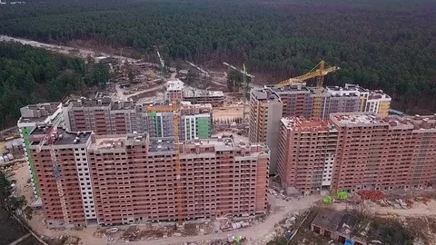 Flight over the construction of a high-rise building made of bricks with cranes Stock Footage 126701129